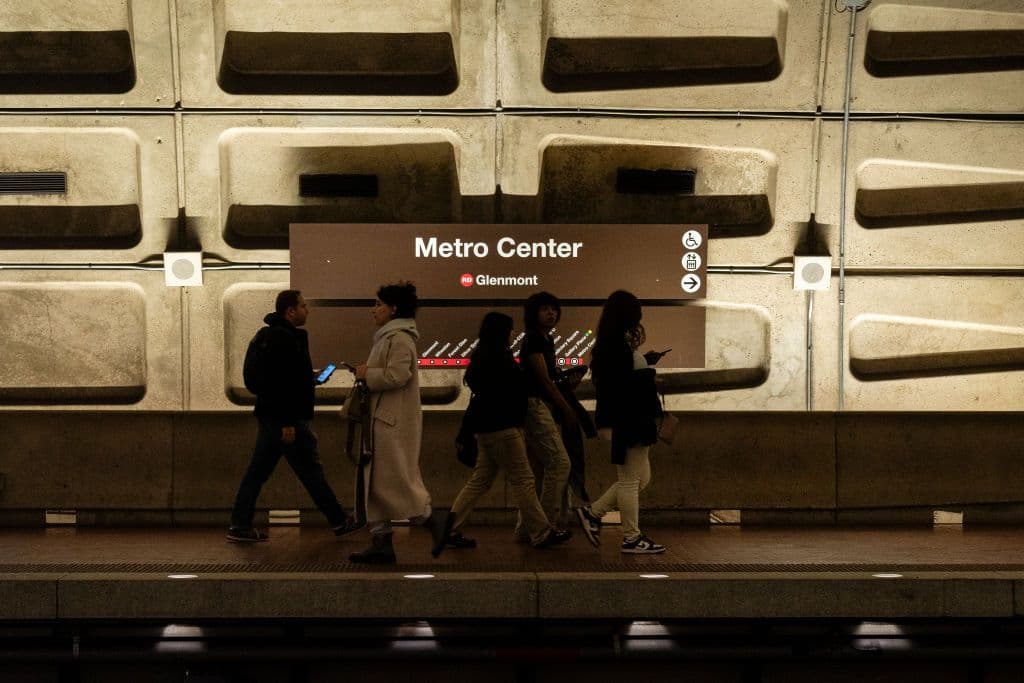 A photo of people walking at the Metro Center platform.