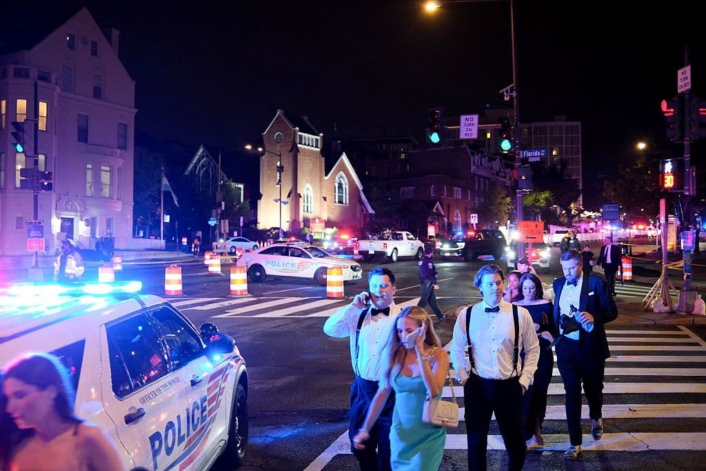 Guests walk away from the Washington Hilton after shots were heard during the White House Correspondents' Dinner. (