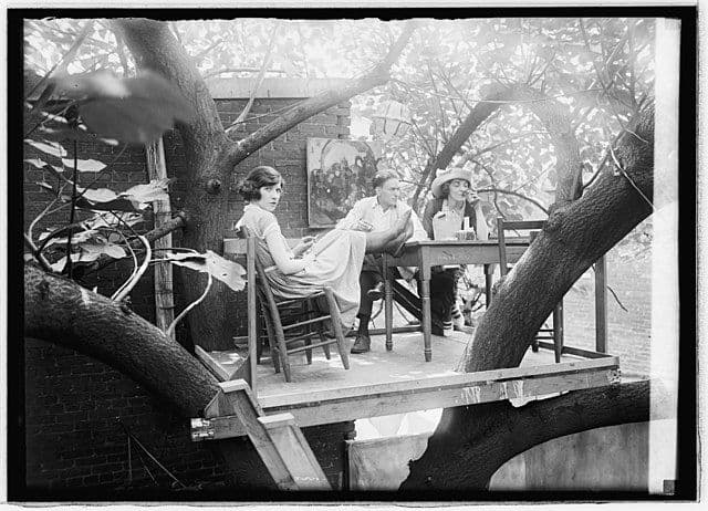 Artist Cleon Throckmorton, his first wife Katherine "Kat" Mullen, and a friend enjoy refreshments in the external treehouse of the Krazy Kat speakeasy.