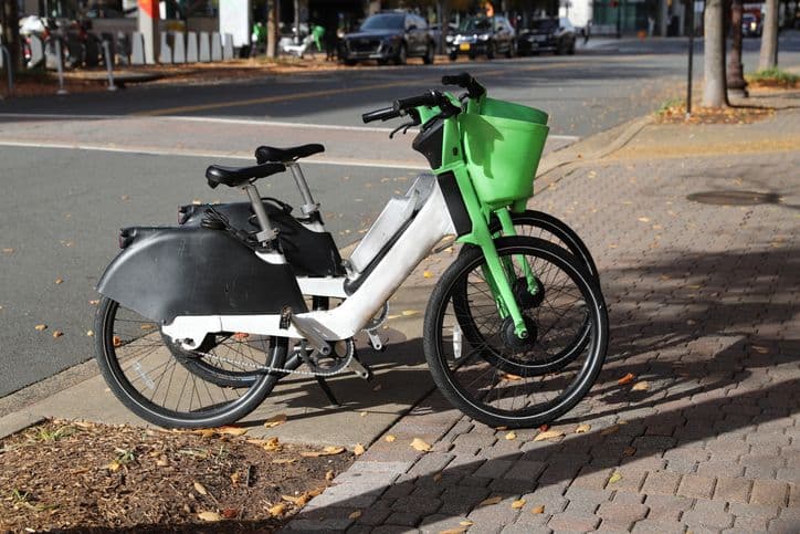 Lime e-bikes parked on the sidewalk.