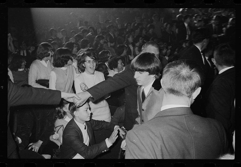 Beatles trying to get through the crowds at their show at the Washington Coliseum.